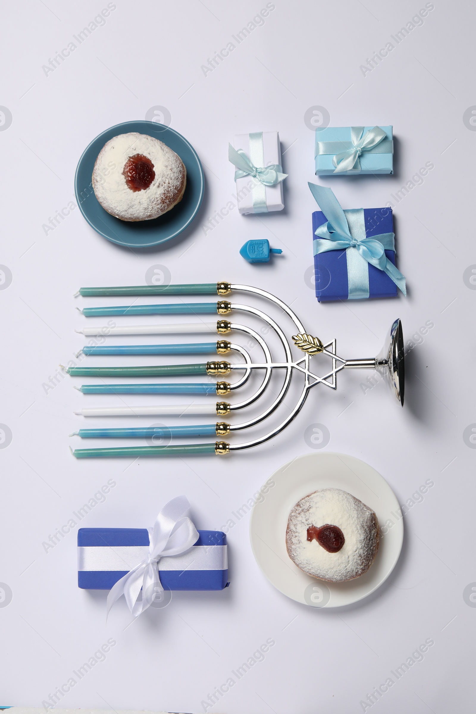 Photo of Flat lay composition with Hanukkah menorah and donuts on white background