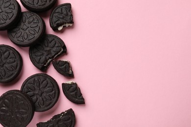 Photo of Tasty sweet sandwich cookies on pink background, flat lay. Space for text