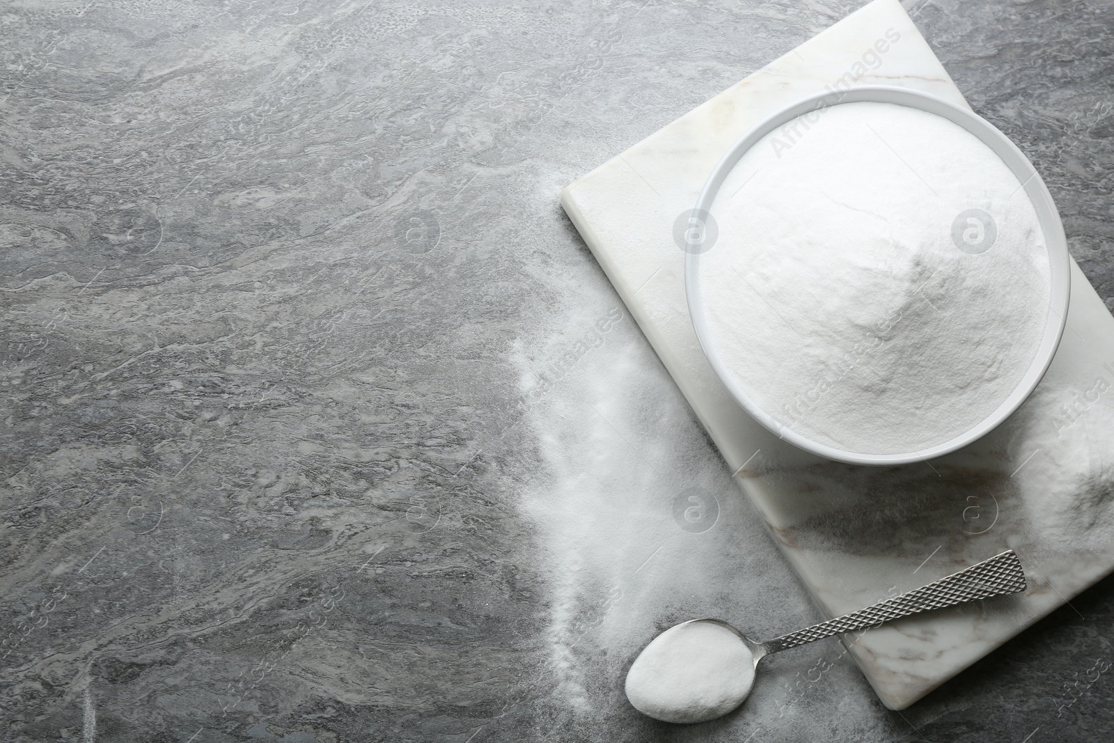 Photo of Baking soda on grey table, flat lay. Space for text