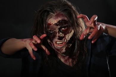 Scary zombie on dark background. Halloween monster