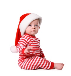 Cute baby in Santa hat and bright Christmas pajamas on white background