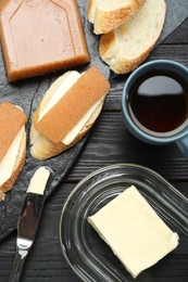 Photo of Tasty sandwiches with quince paste served on black wooden table, flat lay