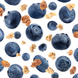 Image of Delicious granola and blueberries falling on white background. Healthy snack  