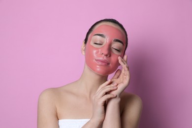 Photo of Woman with pomegranate face mask on pink background