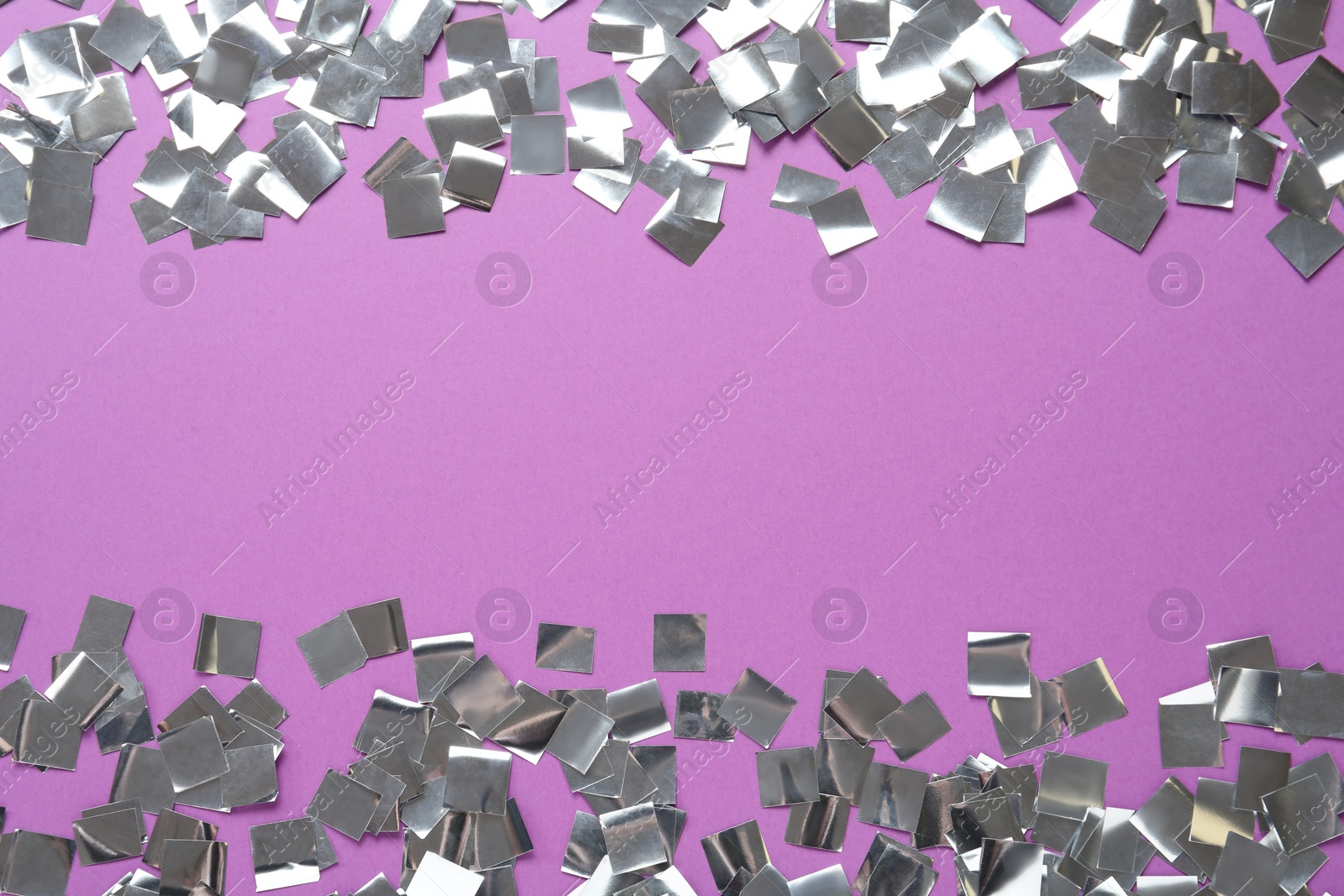 Photo of Shiny silver confetti on violet background, flat lay. Space for text