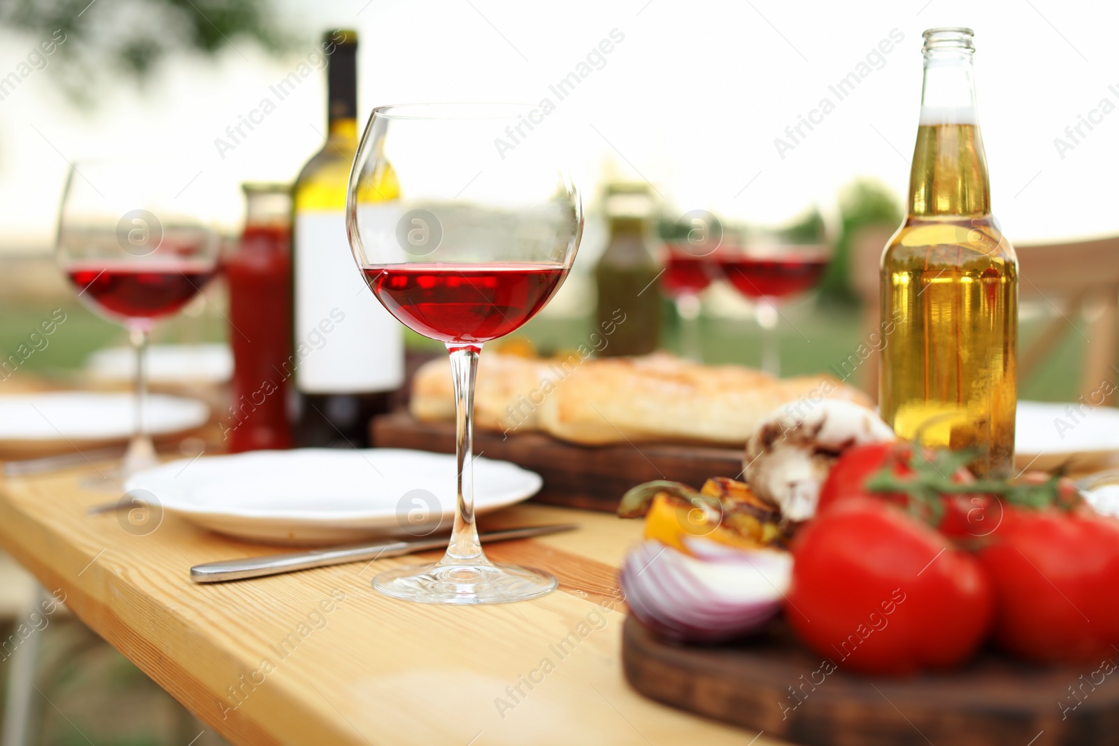 Photo of Table set for barbecue party in countryside