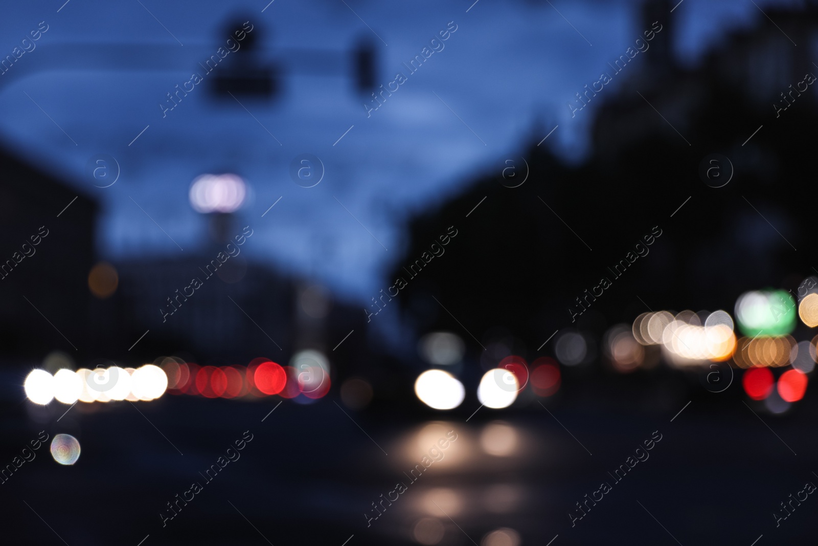 Photo of Blurred view of modern city at evening. Bokeh effect