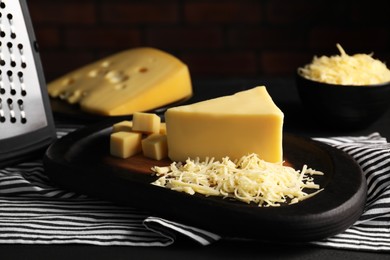 Grated and cut cheese on table, closeup