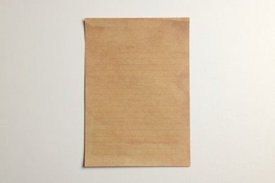 Photo of Sheet of old parchment paper on white background, top view