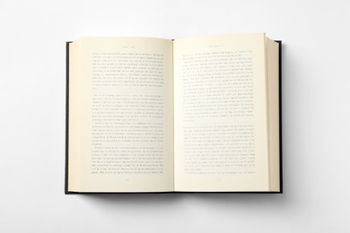 Open book on white background, top view