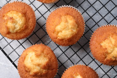 Photo of Delicious sweet muffins on grey textured table, top view