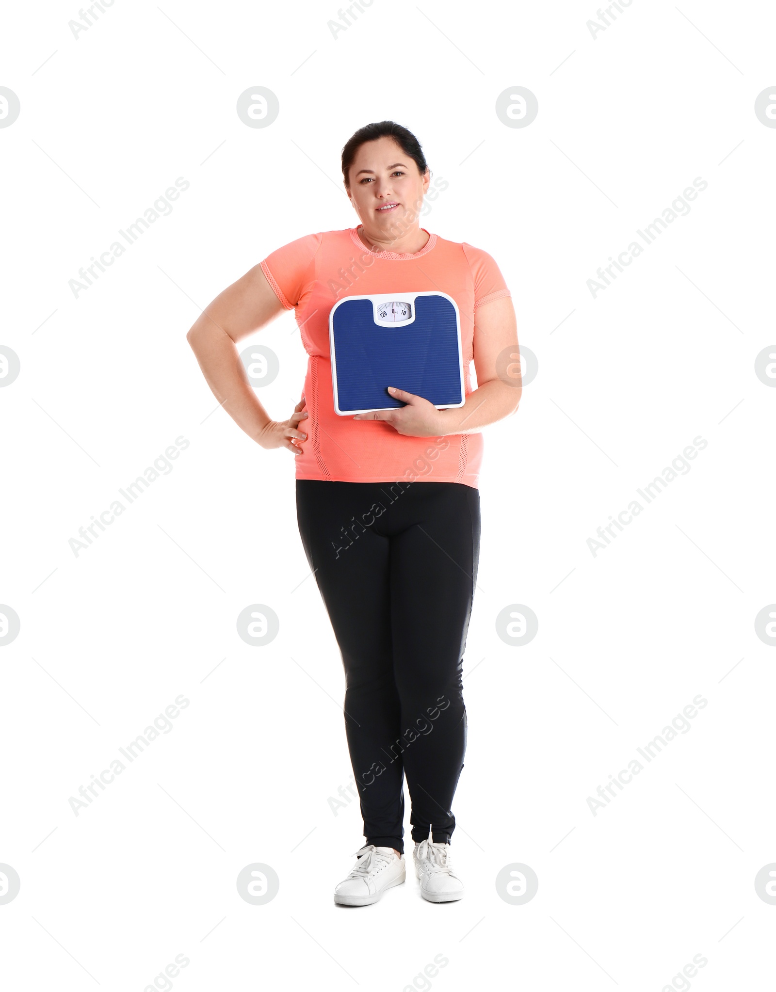 Photo of Overweight woman in sportswear with scales on white background