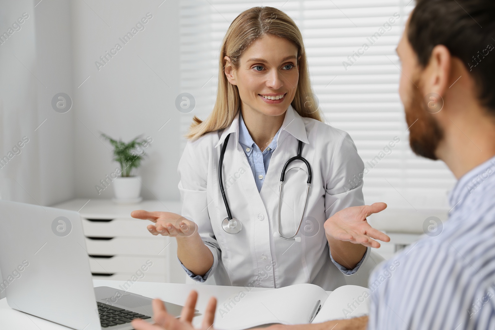 Photo of Patient having appointment with happy doctor in clinic