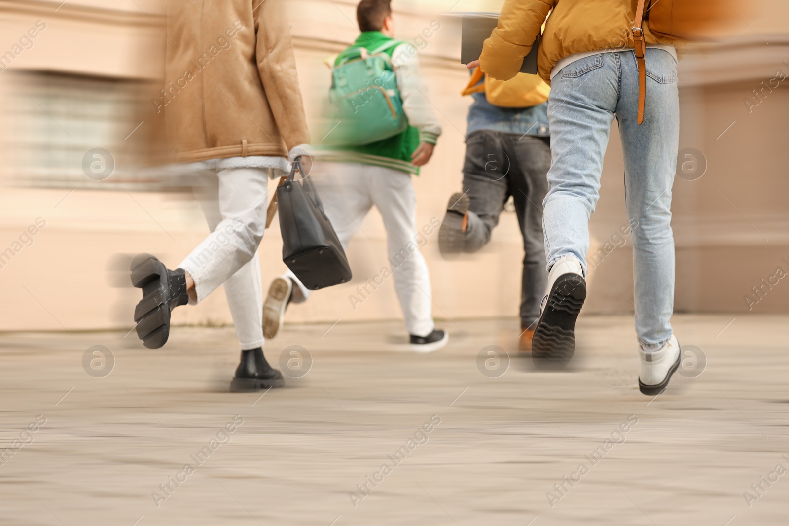 Image of Being late. Group of students running for class. Motion blur effect