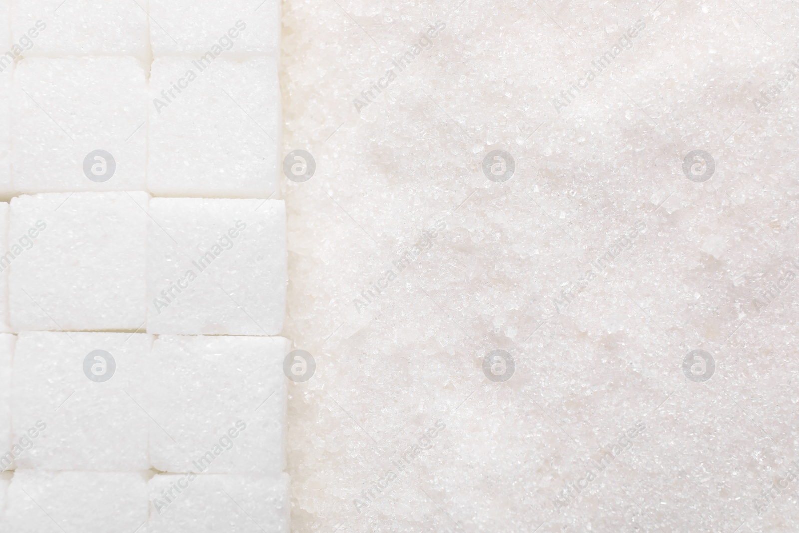 Photo of Different types of white sugar as background, top view. Space for text