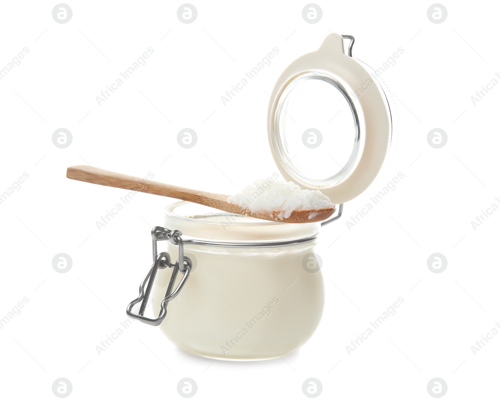 Photo of Jar and spoon with coconut oil on white background