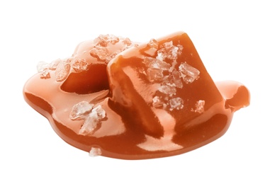 Photo of Caramel candies under tasty sauce with salt isolated on white