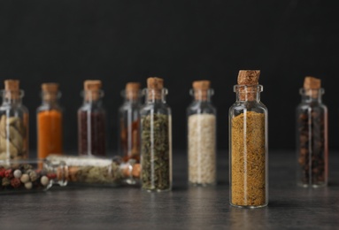 Photo of Bottles with different spices on table