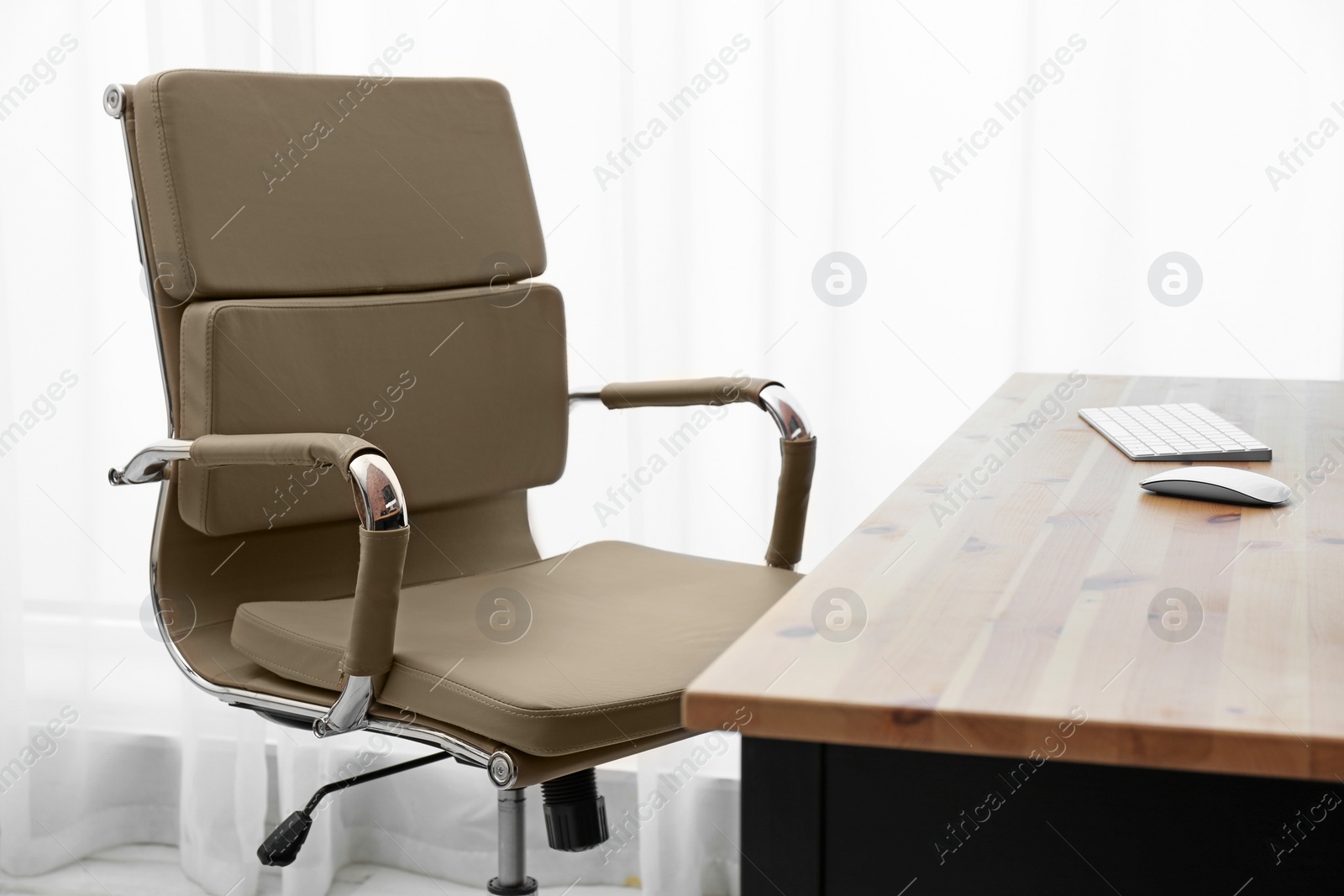 Photo of Modern office chair in stylish workplace interior