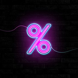 Image of Glowing neon percent sign on brick wall