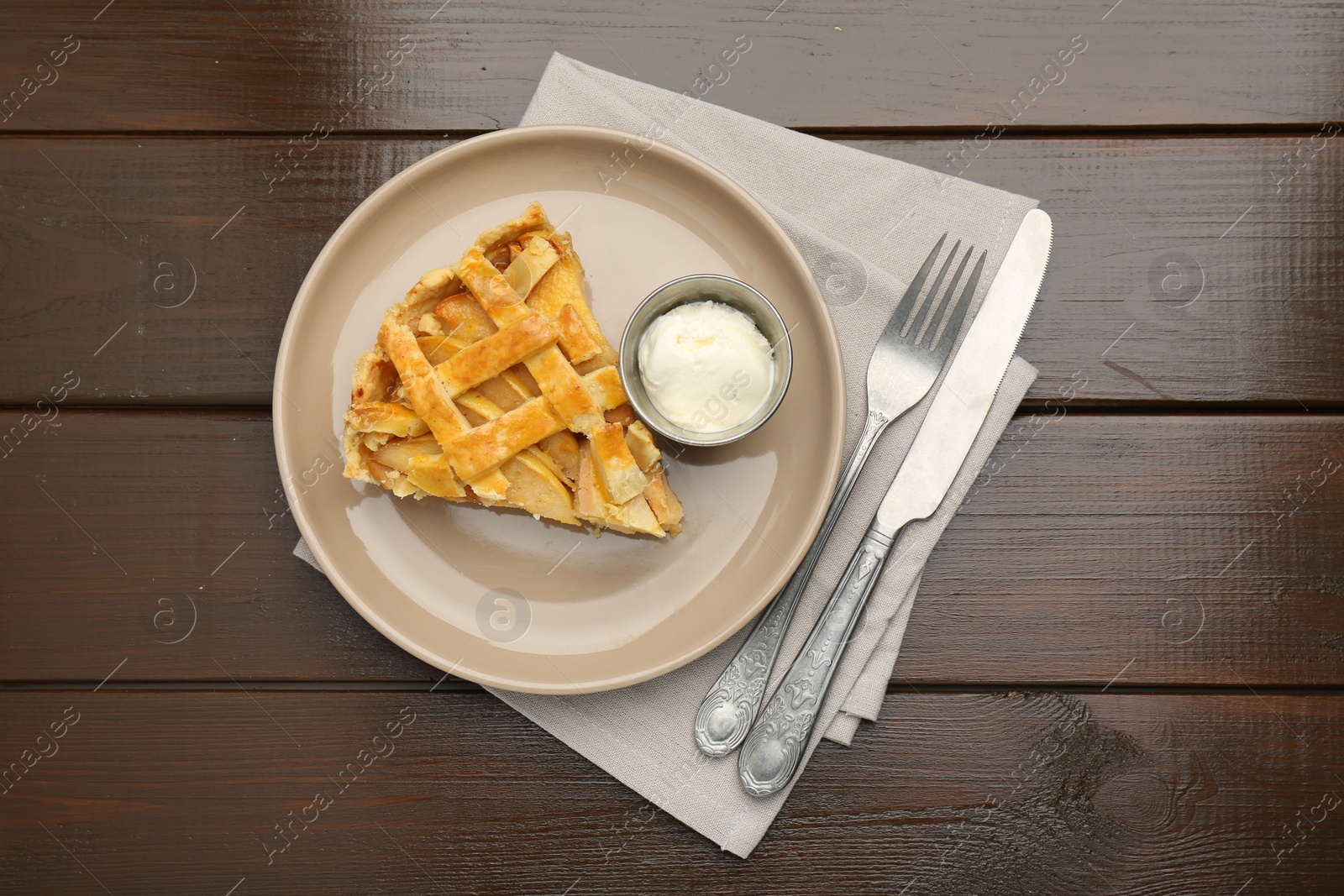 Photo of Piece of tasty homemade quince pie served on wooden table, flat lay