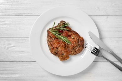 Plate with tasty grilled meat on table, top view