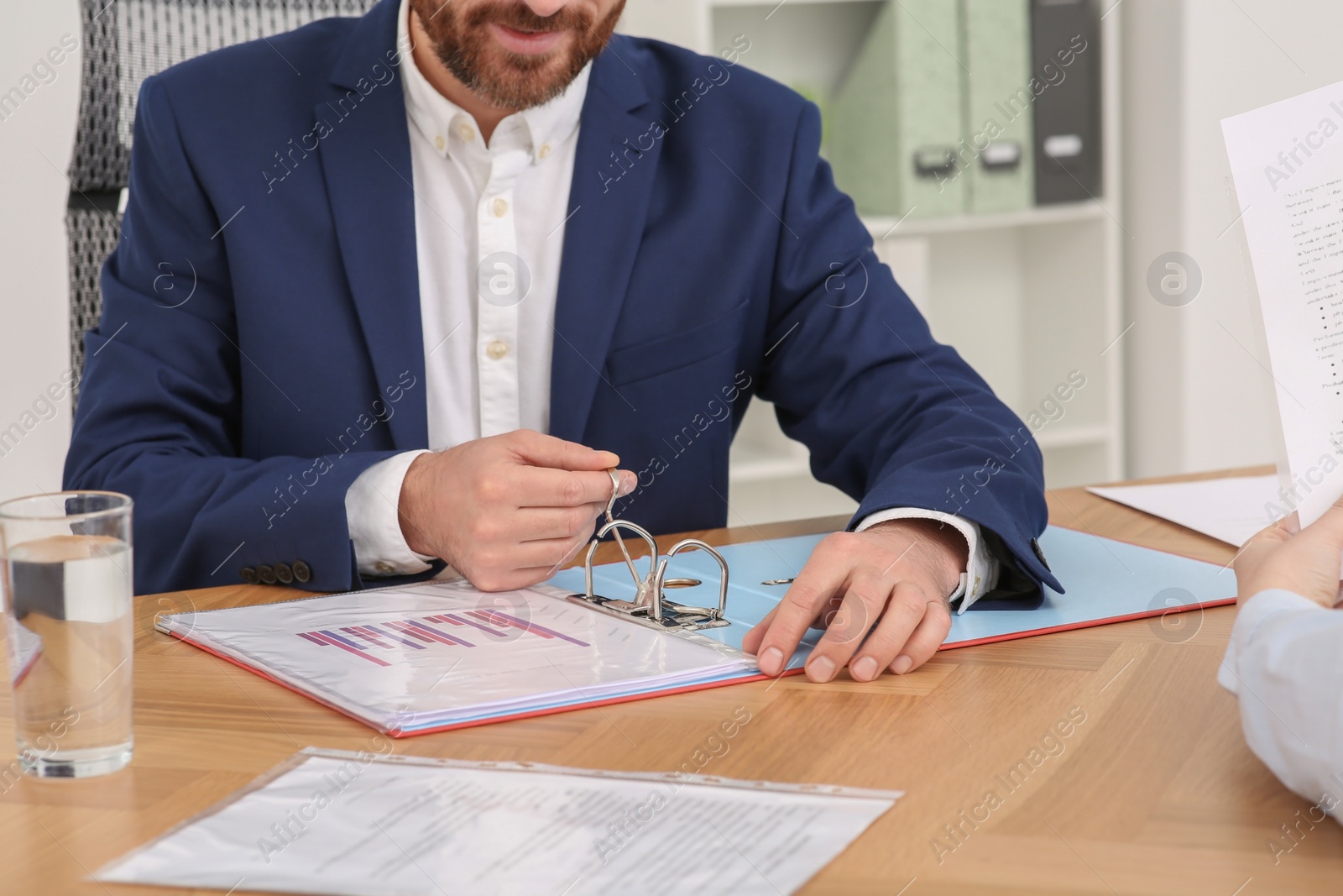 Photo of Businesspeople working with documents at wooden table in office, closeup