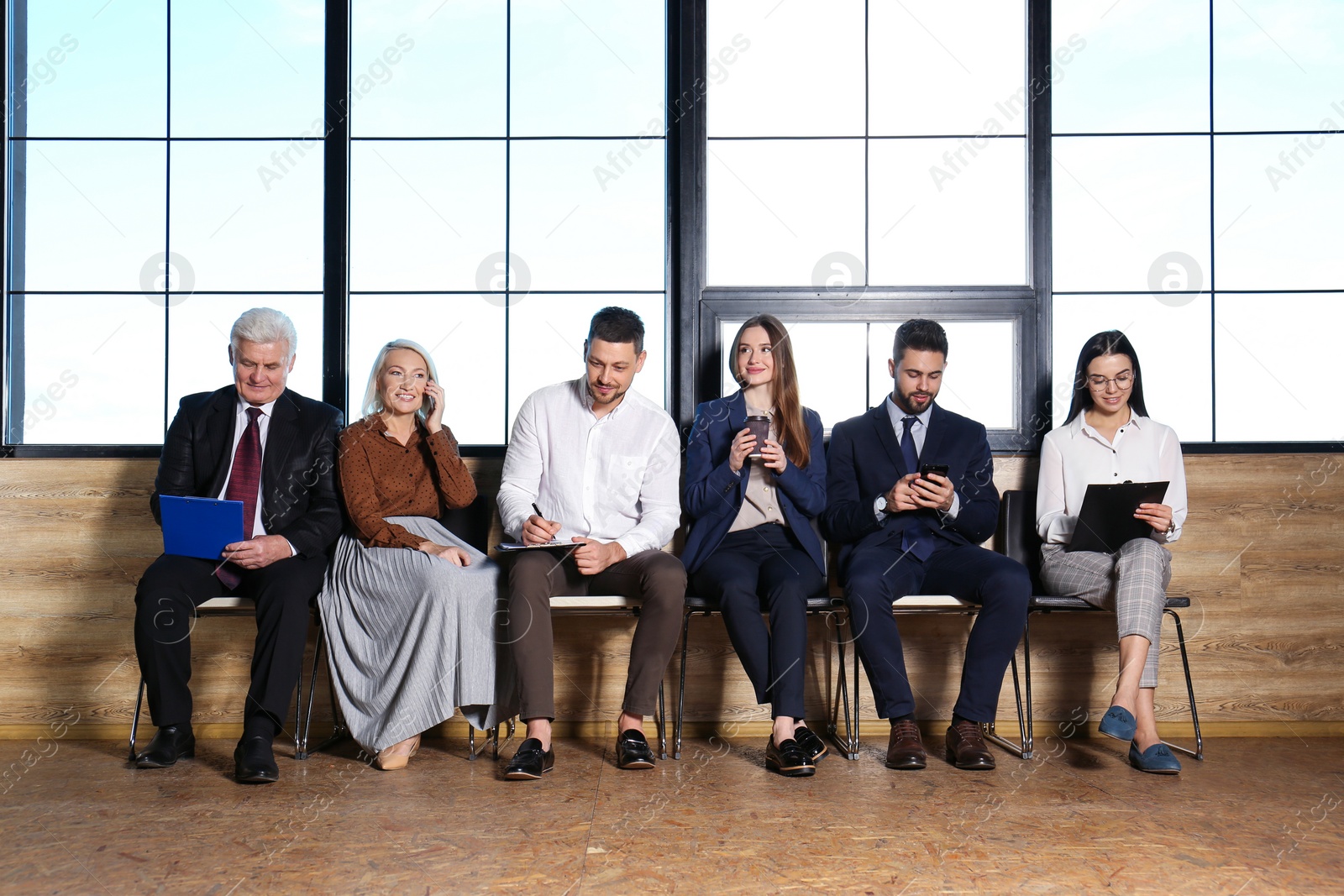 Photo of People waiting for job interview in office hall