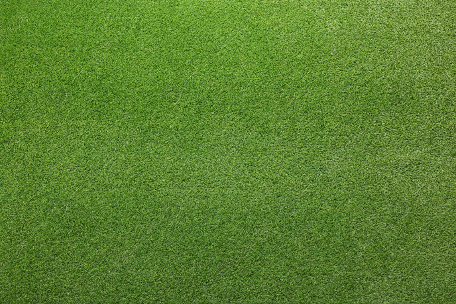 Photo of Green artificial grass as background, top view