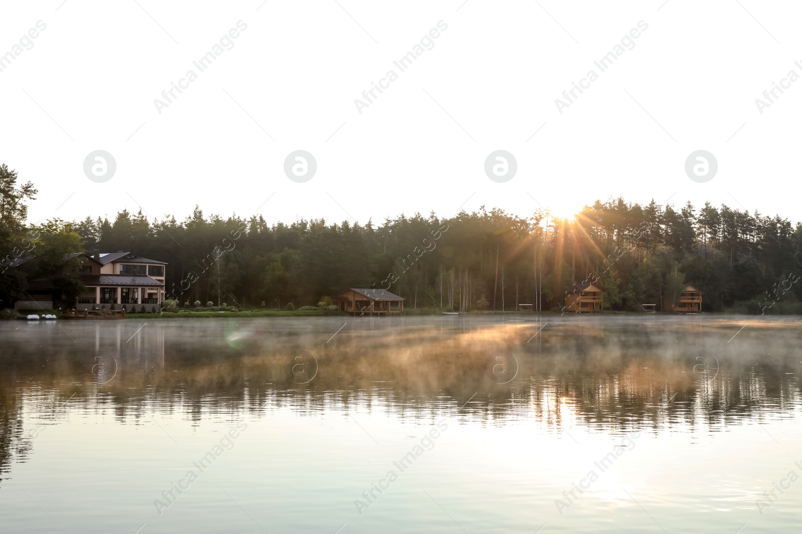 Photo of Beautiful landscape with forest and houses near lake. Camping season