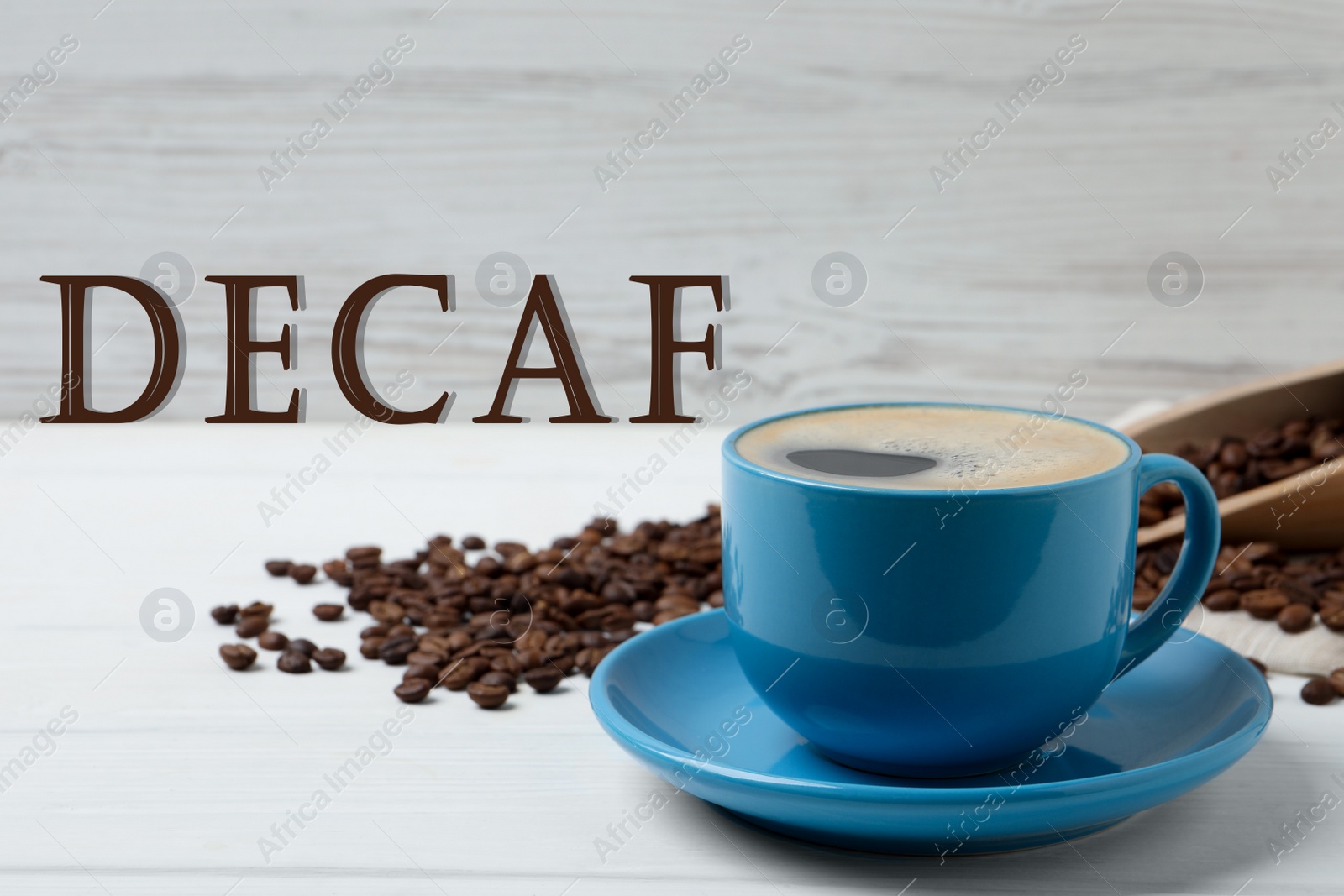 Image of Cup of aromatic decaf coffee and beans on white table