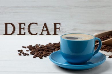 Image of Cup of aromatic decaf coffee and beans on white table