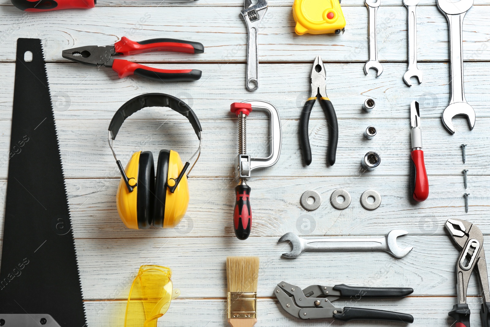 Photo of Flat lay composition with construction tools on wooden background