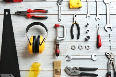 Photo of Flat lay composition with construction tools on wooden background