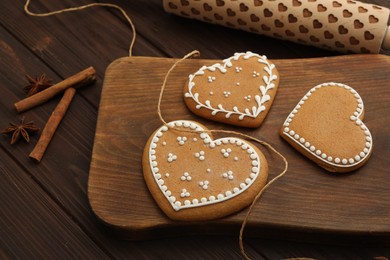 Delicious heart shaped Christmas cookies on wooden table