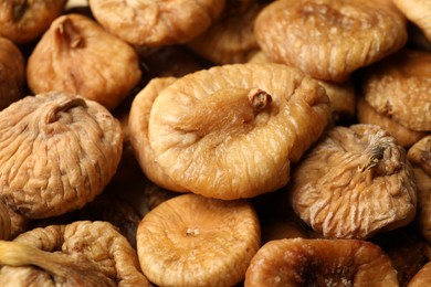 Many tasty dried figs as background, closeup