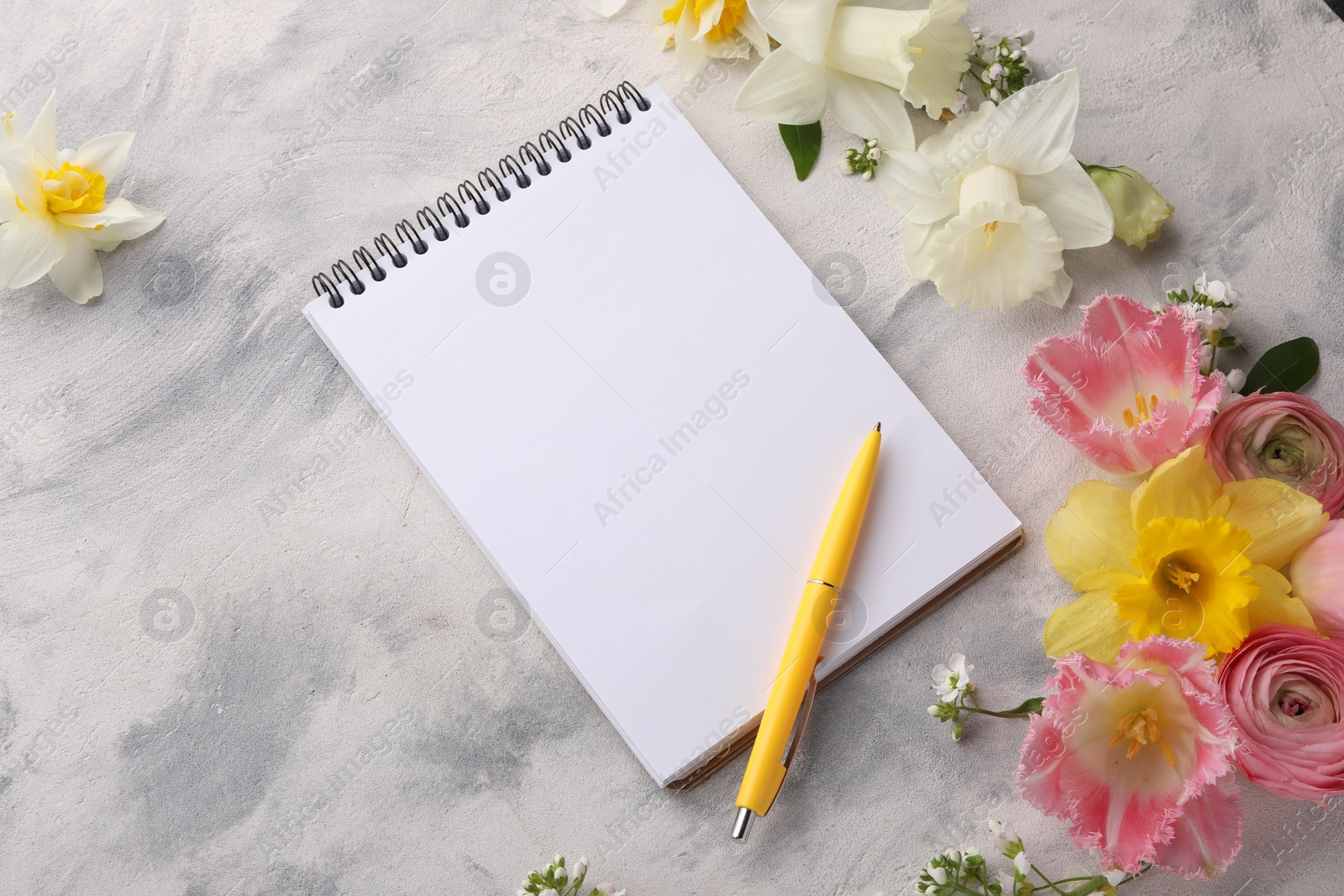 Photo of Guest list. Notebook, pen and beautiful flowers on gray textured background, above view. Space for text