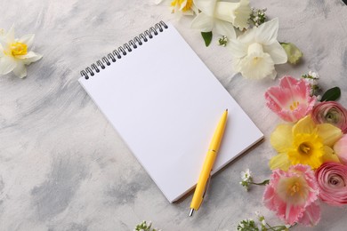 Photo of Guest list. Notebook, pen and beautiful flowers on gray textured background, above view. Space for text