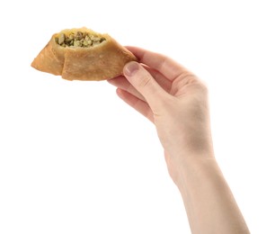 Photo of Woman holding fresh cut samosa on white background, closeup