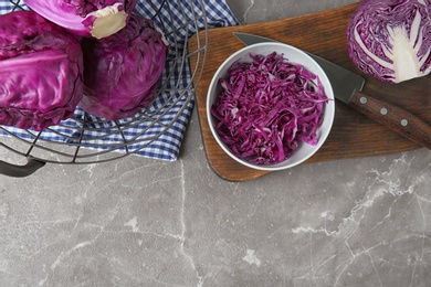 Photo of Flat lay composition with shredded red cabbage on marble table