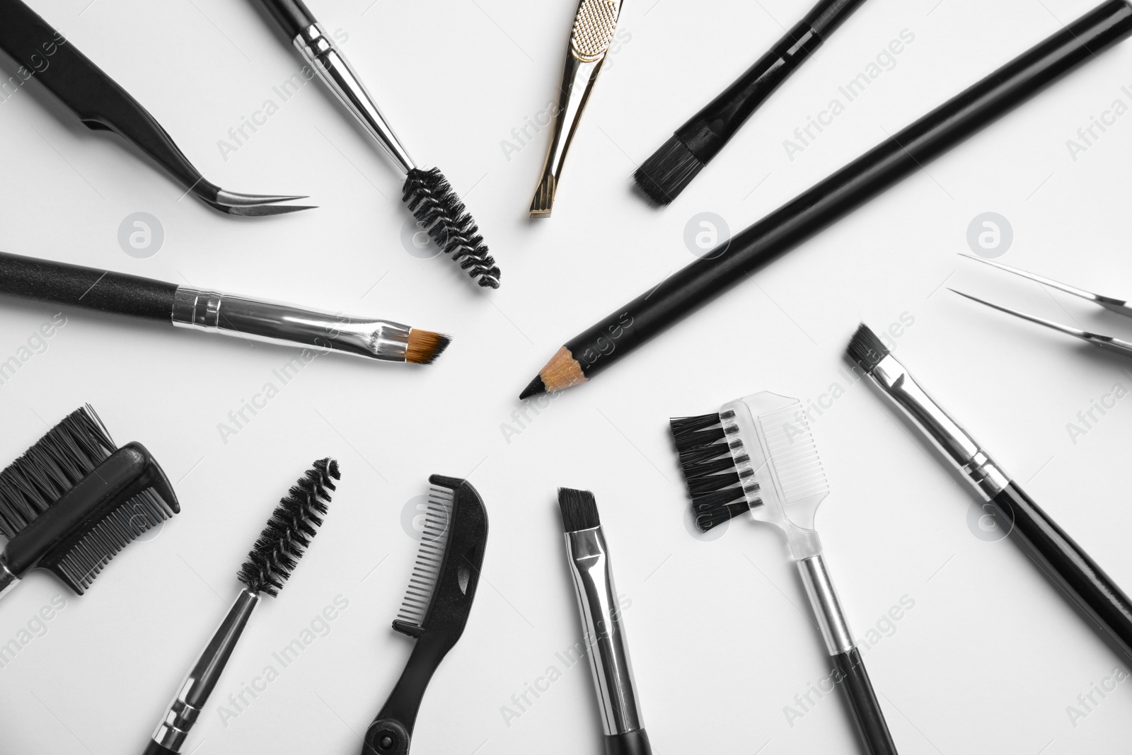 Photo of Set of professional eyebrow tools on white background, flat lay