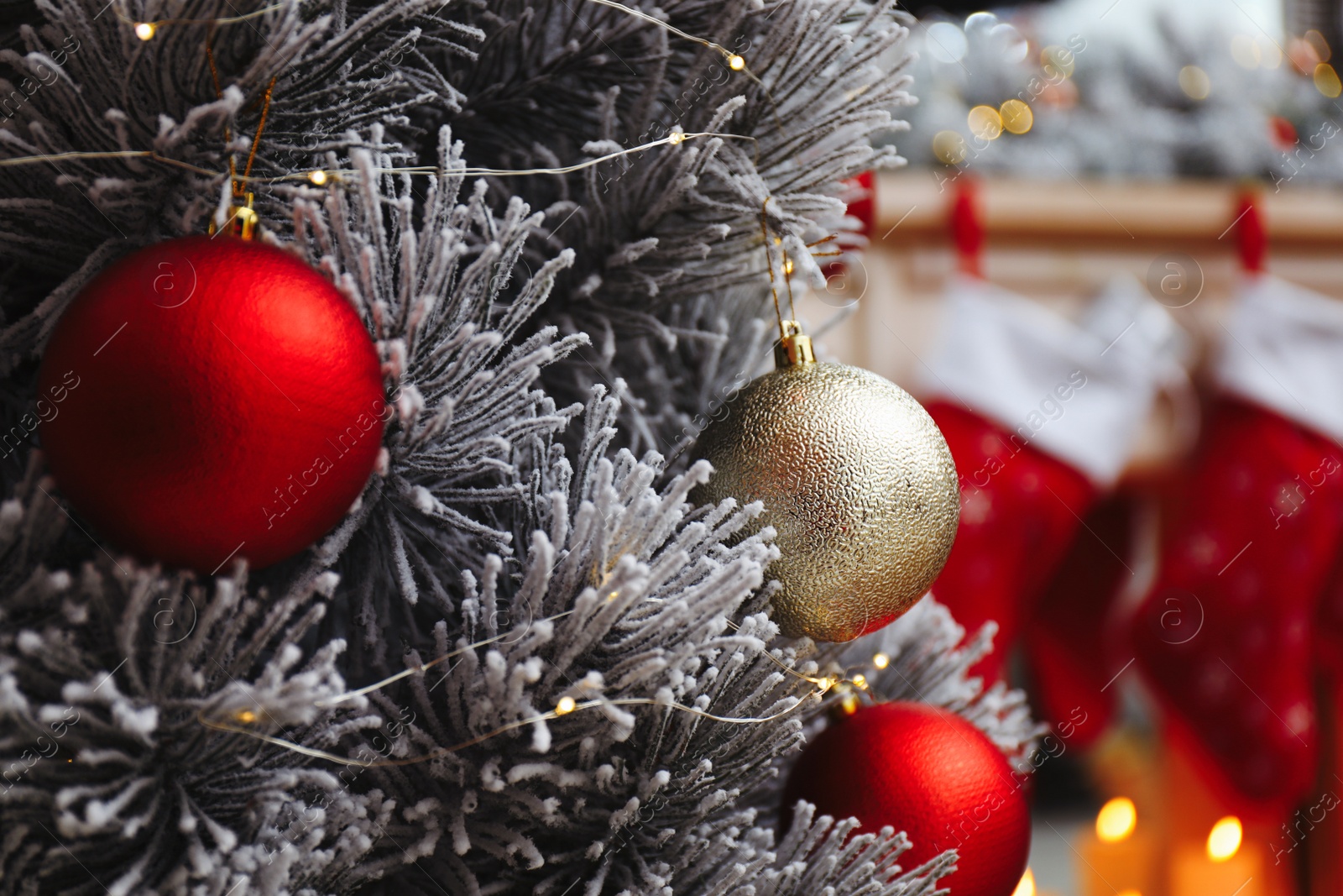 Photo of Beautiful decorated Christmas tree in festive room interior, closeup