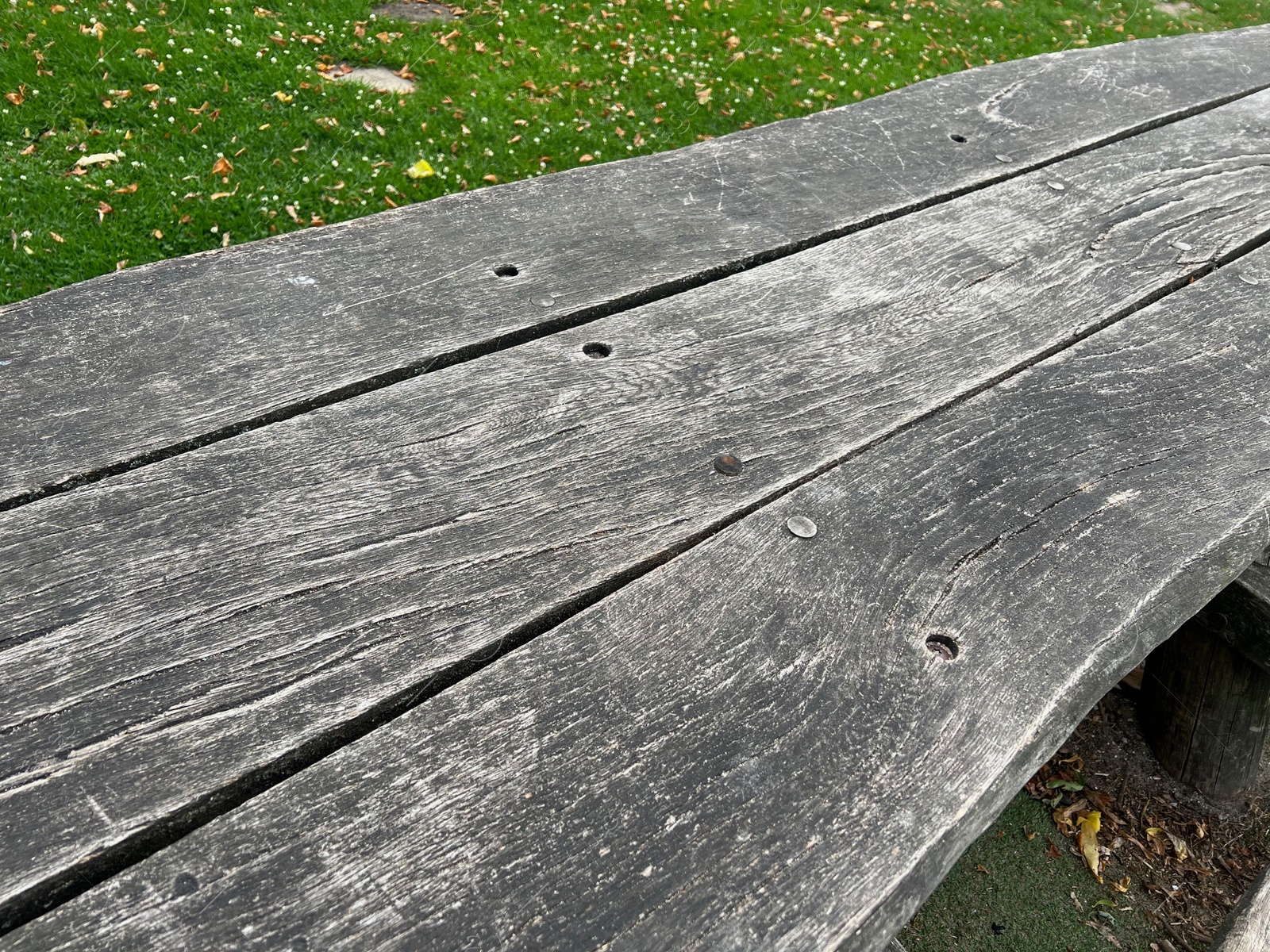 Photo of Empty wooden picnic table in park, closeup