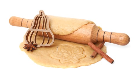 Photo of Cookie cutter, dough, spices and rolling pin on white background