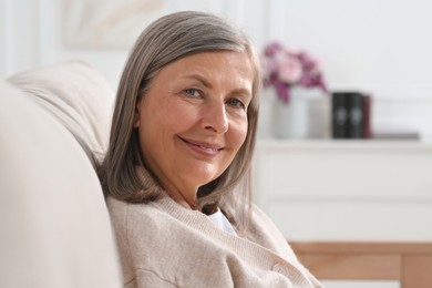 Photo of Portrait of beautiful senior woman on sofa at home