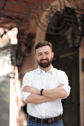 Portrait of young businessman in stylish outfit outdoors