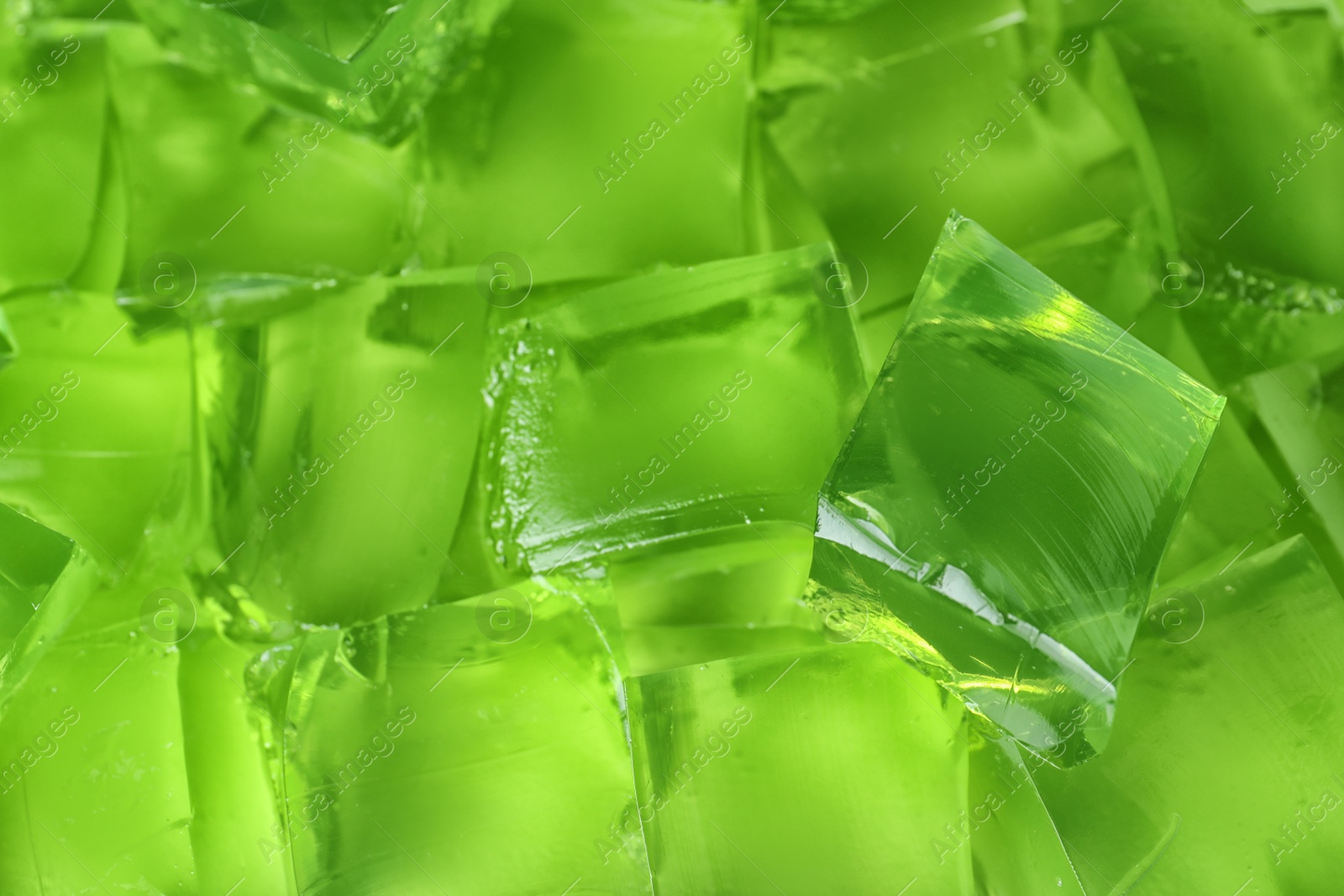 Photo of Green jelly cubes as background, closeup view