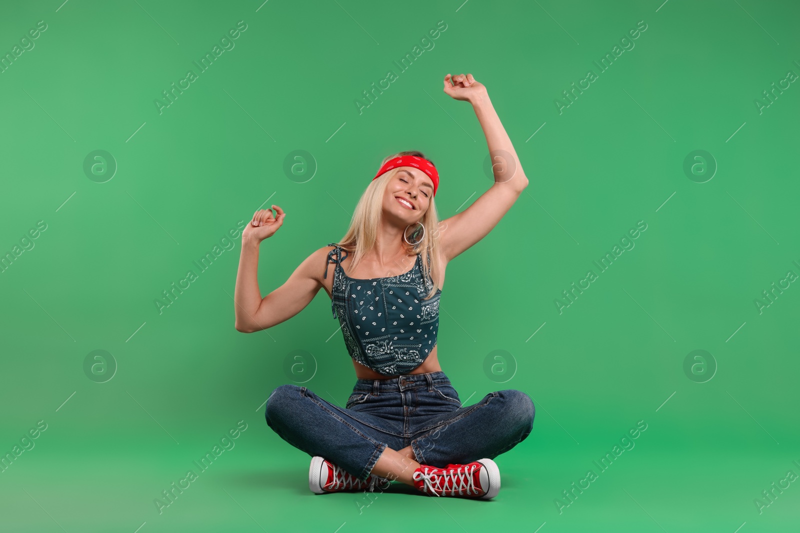 Photo of Portrait of happy hippie woman on green background