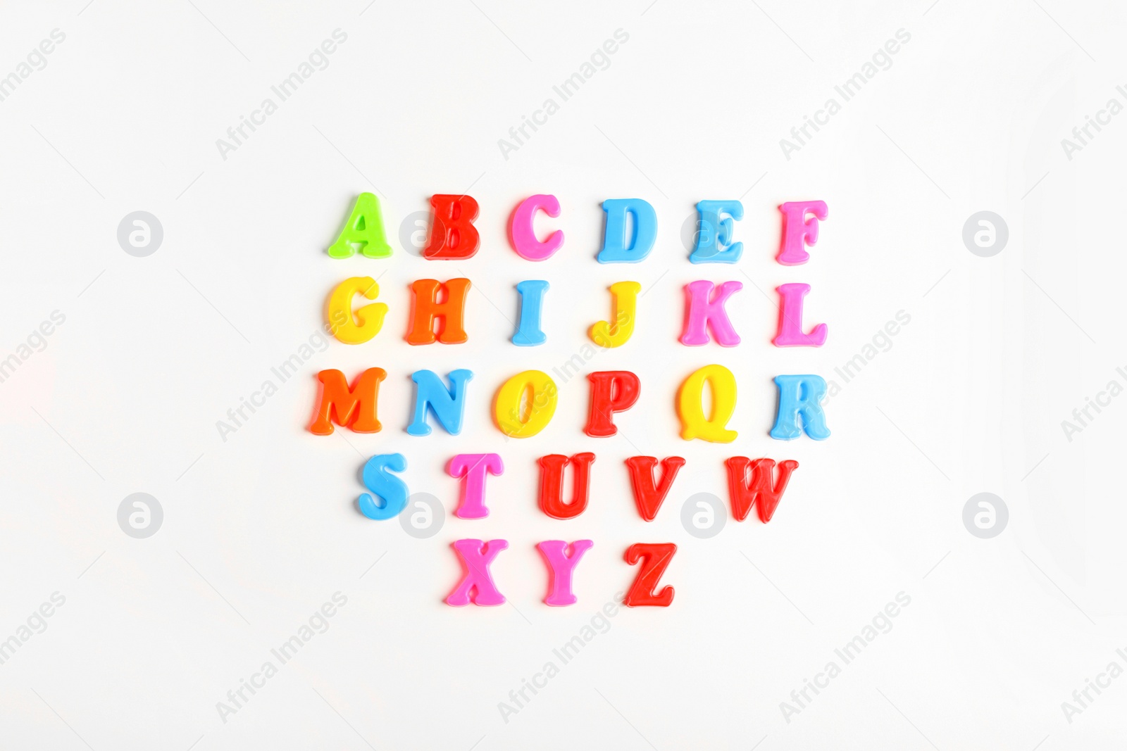 Photo of Colorful magnetic letters on white background, flat lay. Alphabetical order