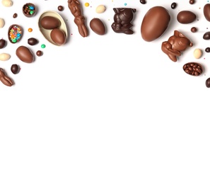 Photo of Flat lay composition with chocolate Easter eggs and space for text on white background